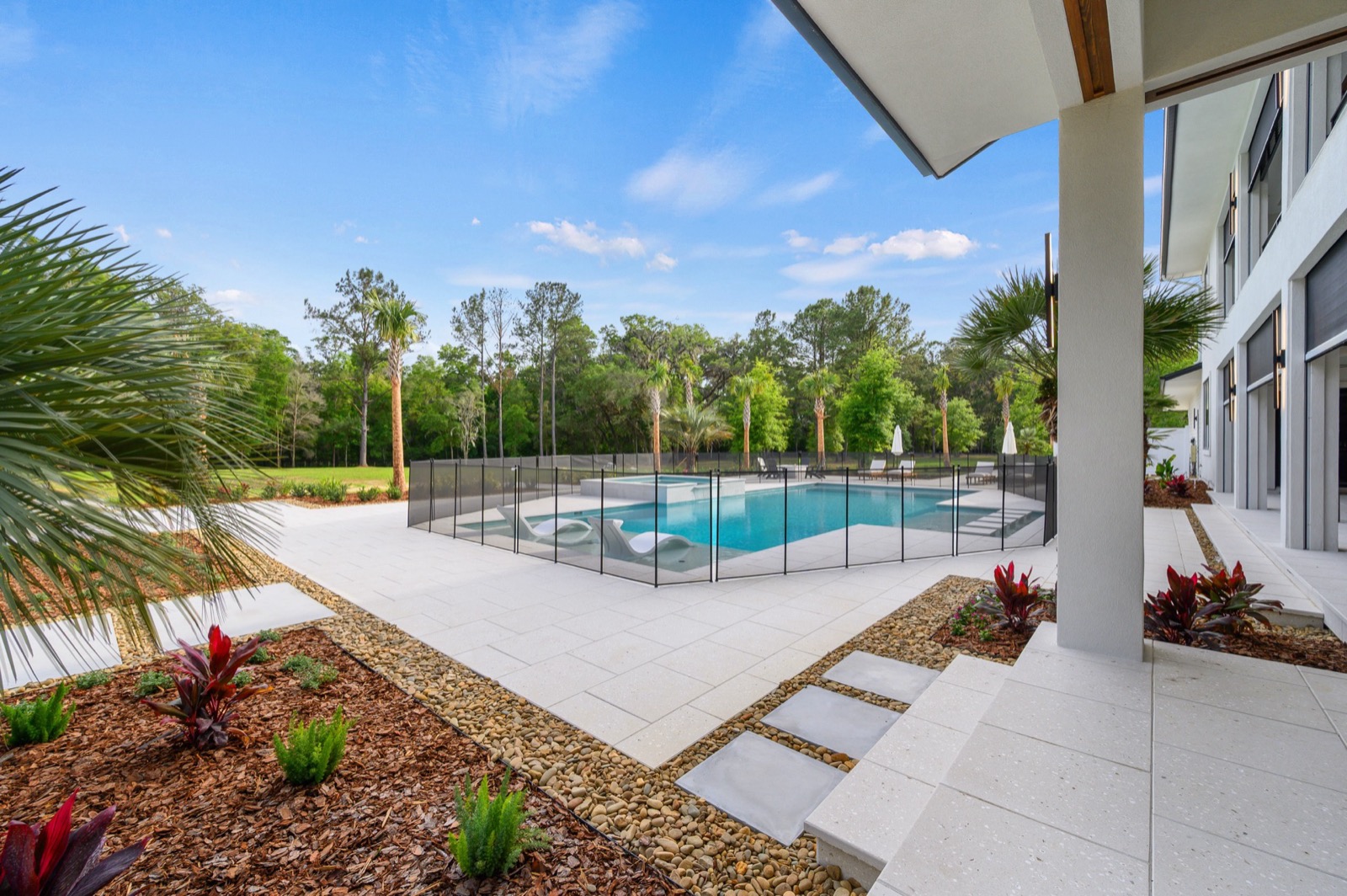 Poolside screen enclosure with motorized screens
